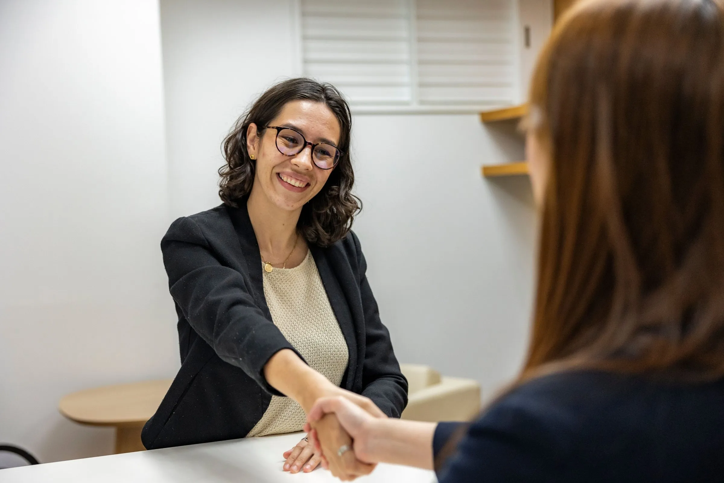 Hiring manager shaking hands with a candidate after an interview